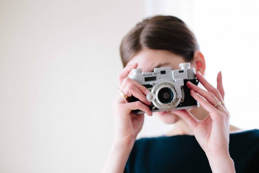 Woman with a camera taking pictures to presentations